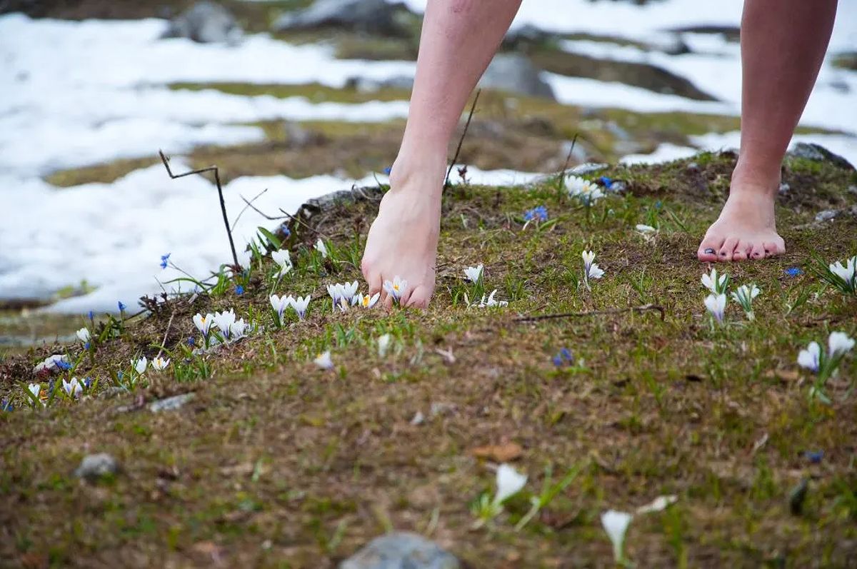 Woman with bare feet on grass